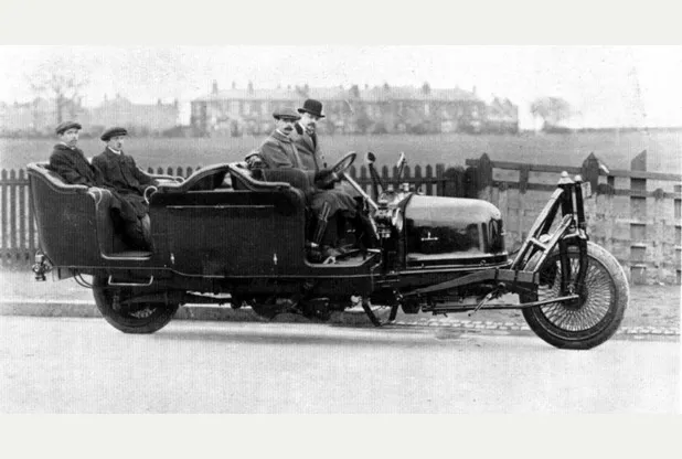 Historic 1914 Shilovsky gyrocar balancing on two wheels with passengers